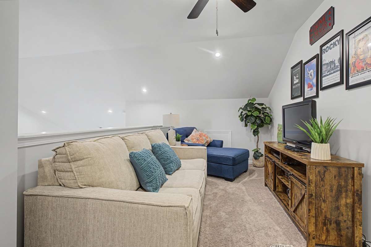 The upstairs loft offers versatile possibilities. Perfect for a home office, media room, or children’s playroom.