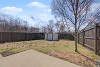 Spacious and fenced backyard with shed included