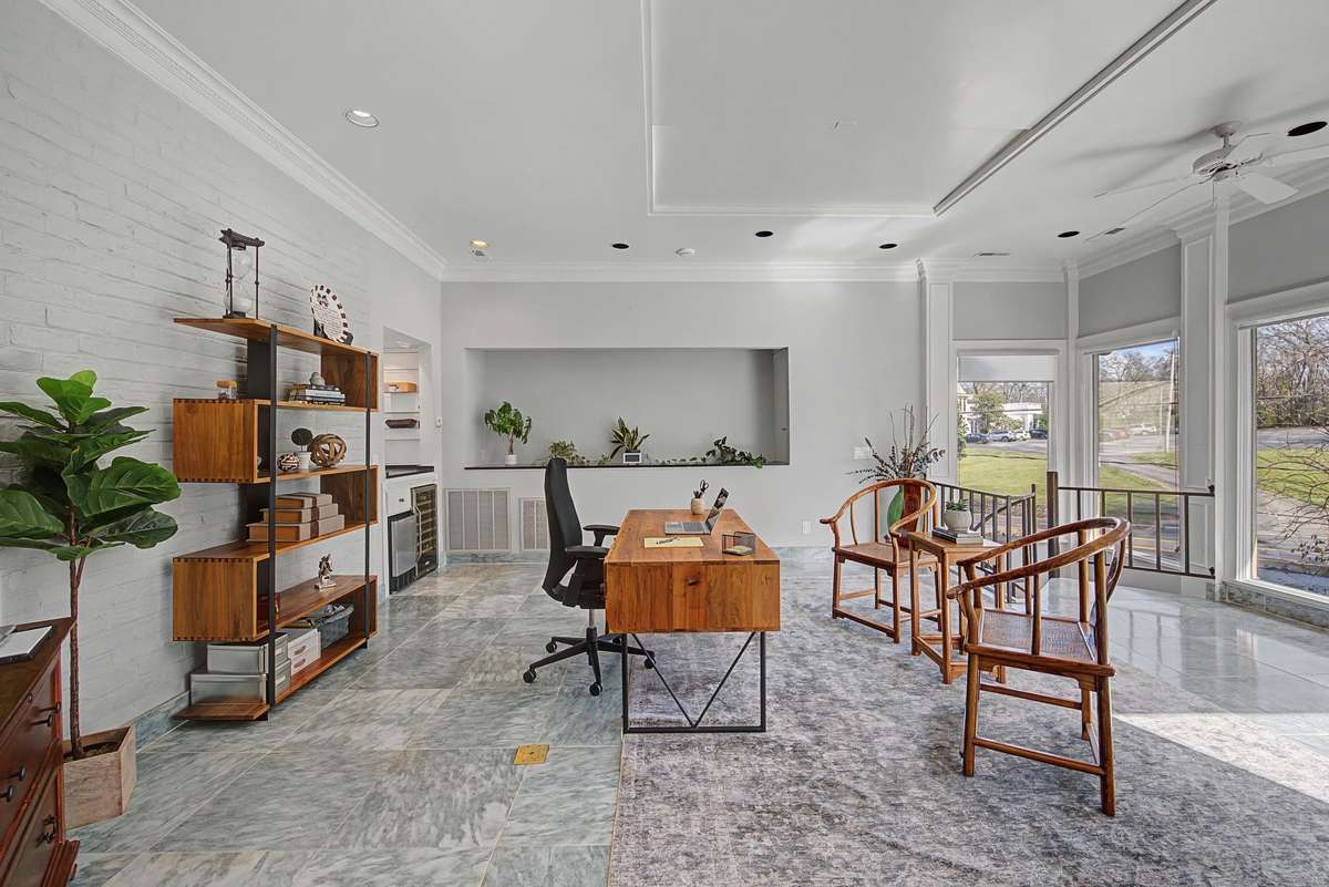 Office/Sunroom with marble floors, wet bar and circular staircase to recreation room.