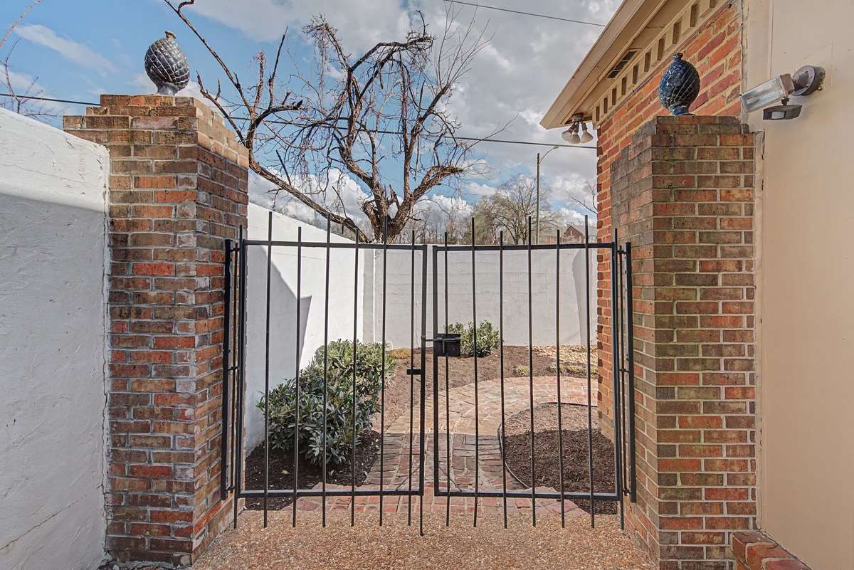 Gated entrance to backyard from garage area.