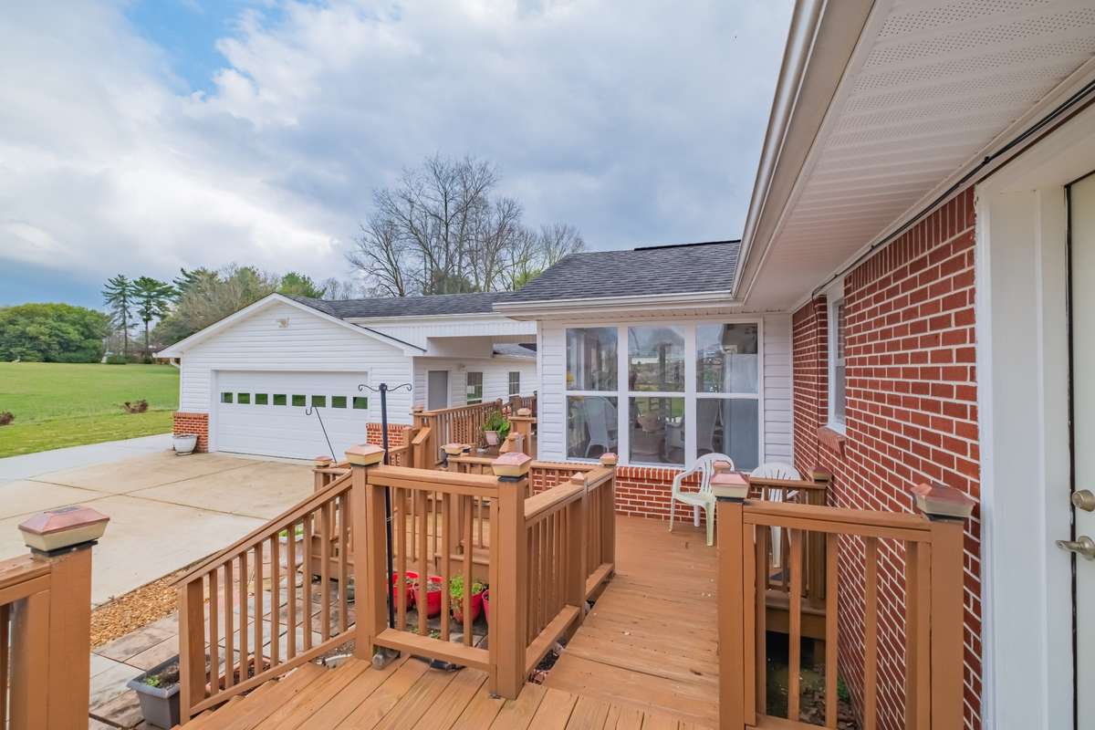 Sprawling deck across the back of the house from the Sunroom to the Utility Room