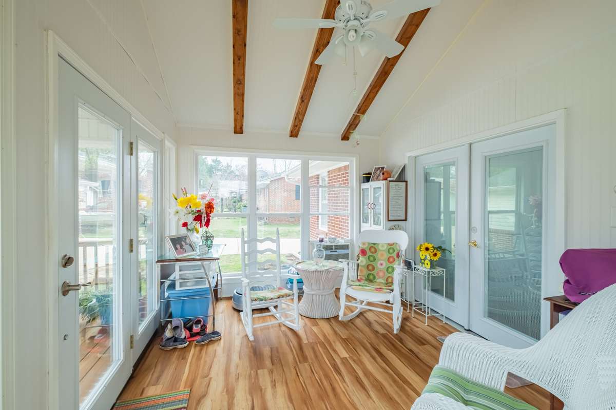 Sunroom with vaulted ceiling and exposed beams
