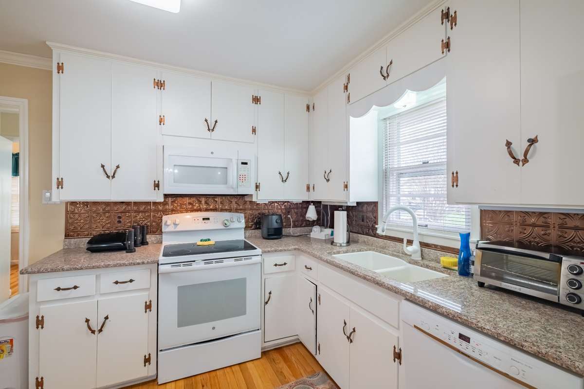 Cabinets have granite counter tops with decorative edges
