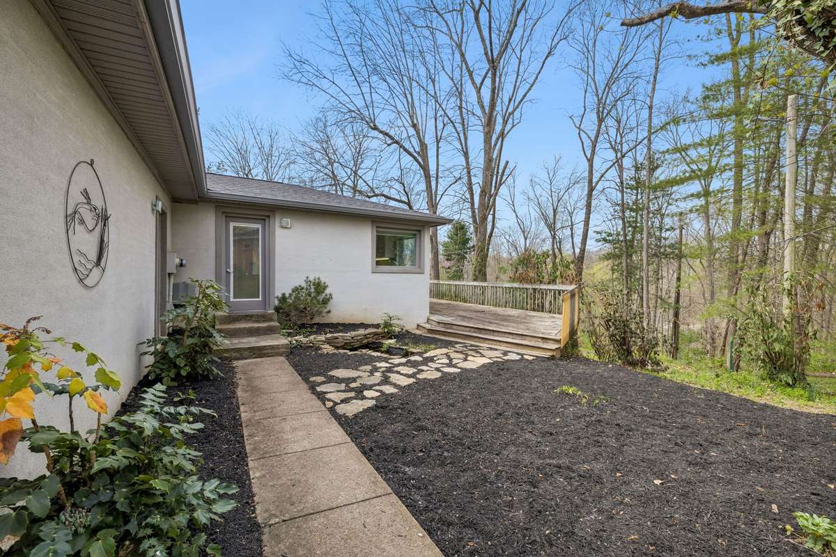 Rear walkway access to kitchen, garage and deck.