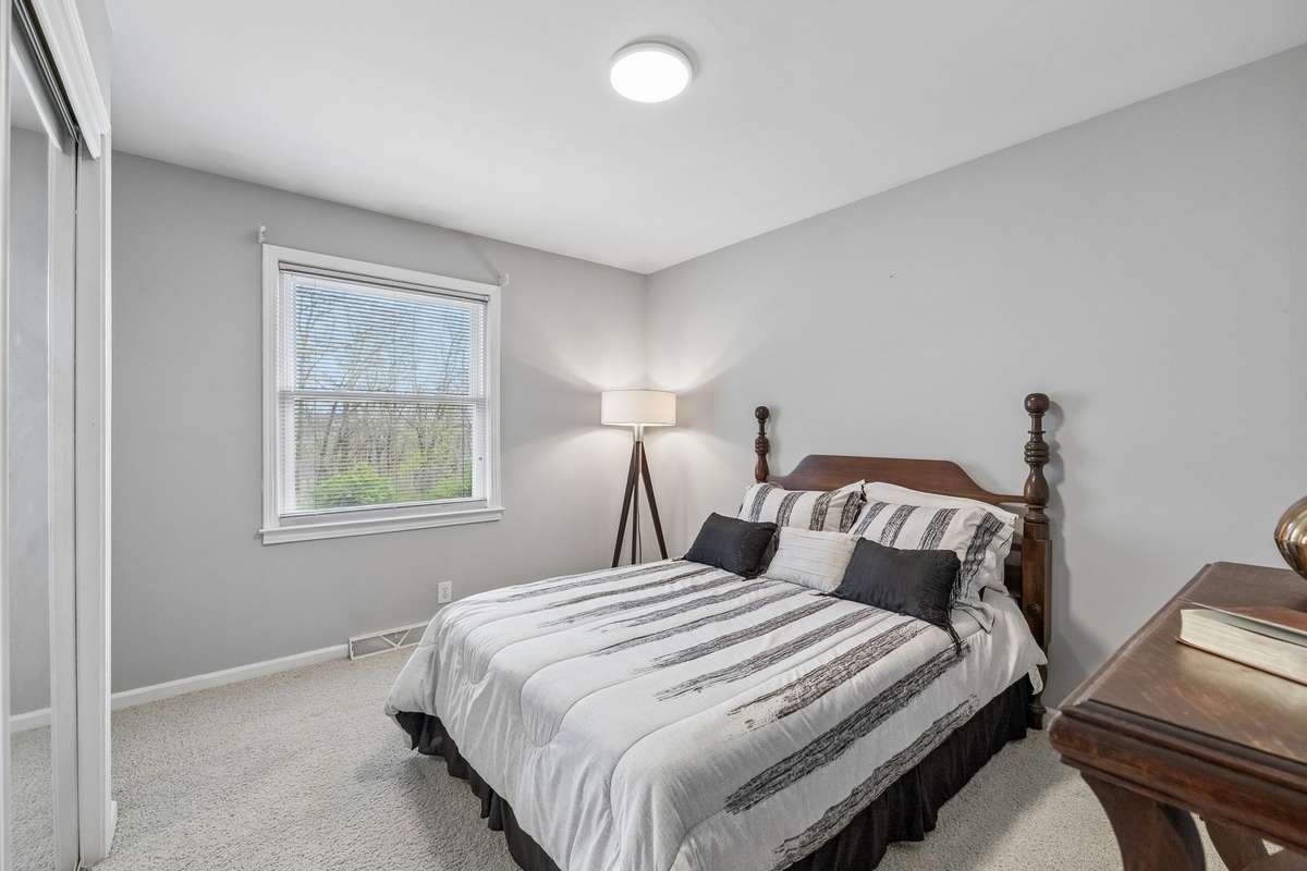 Guest bedroom with double closet with full bath