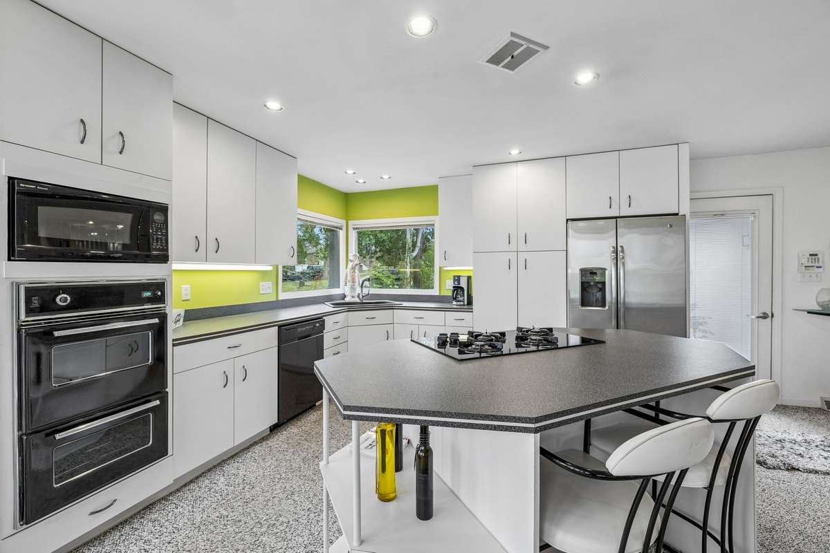 Kitchen has lots of cabinets and a pantry.