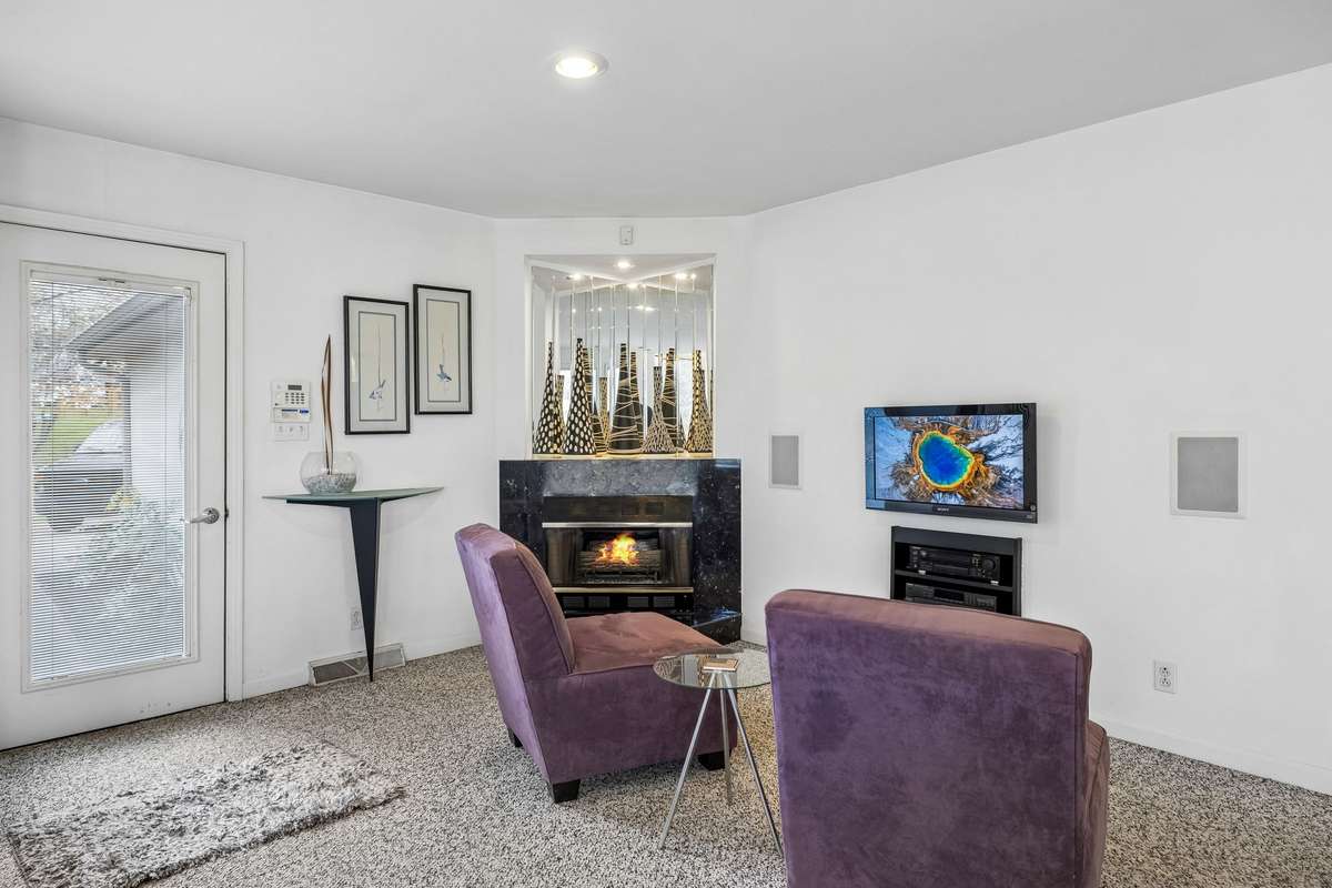 Sitting area & fireplace in kitchen leading to the back entrance