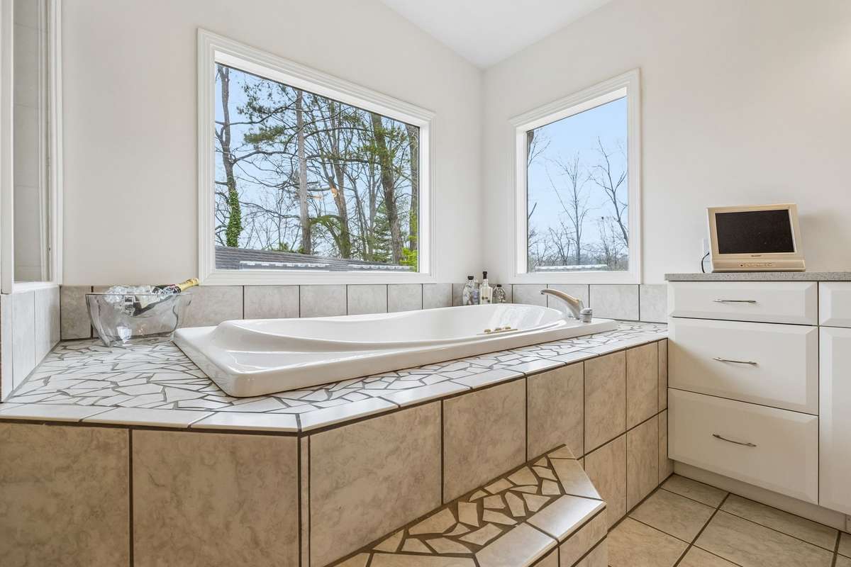 Two person jetted spa tub with custom tile surround