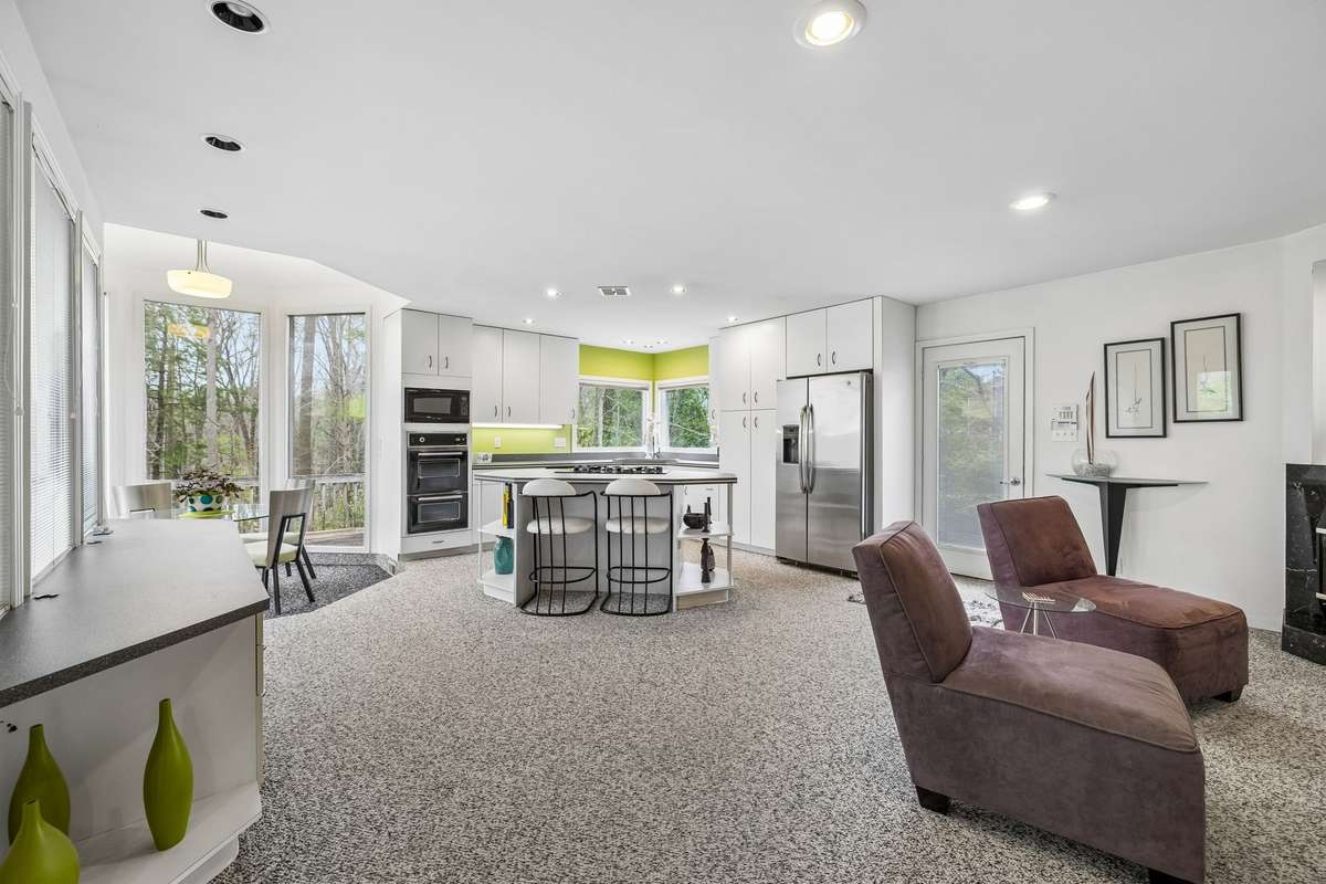 Kitchen has sitting area and fireplace, desk/serving area