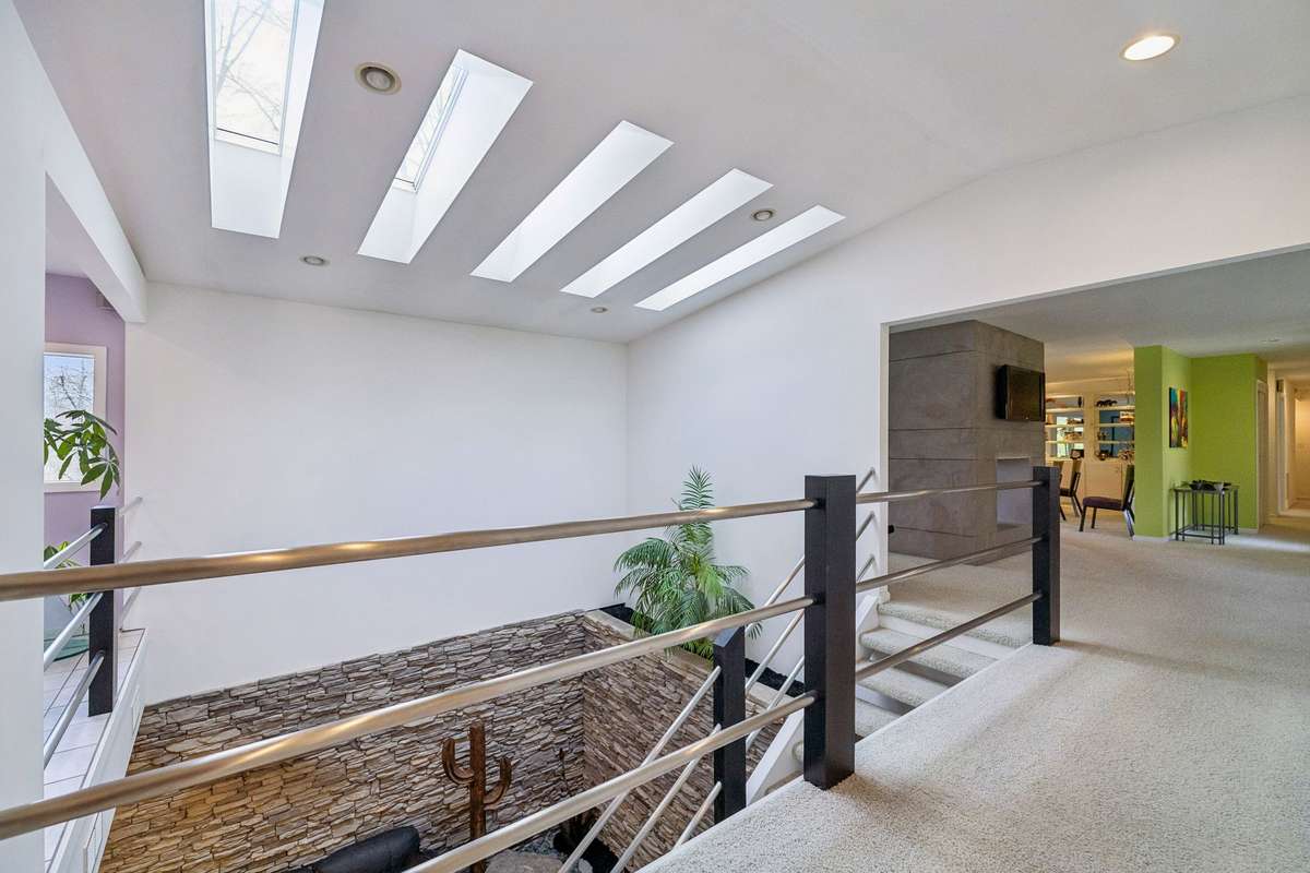 Skylights overlooking the sitting area in lower level. Custom stonework with planter