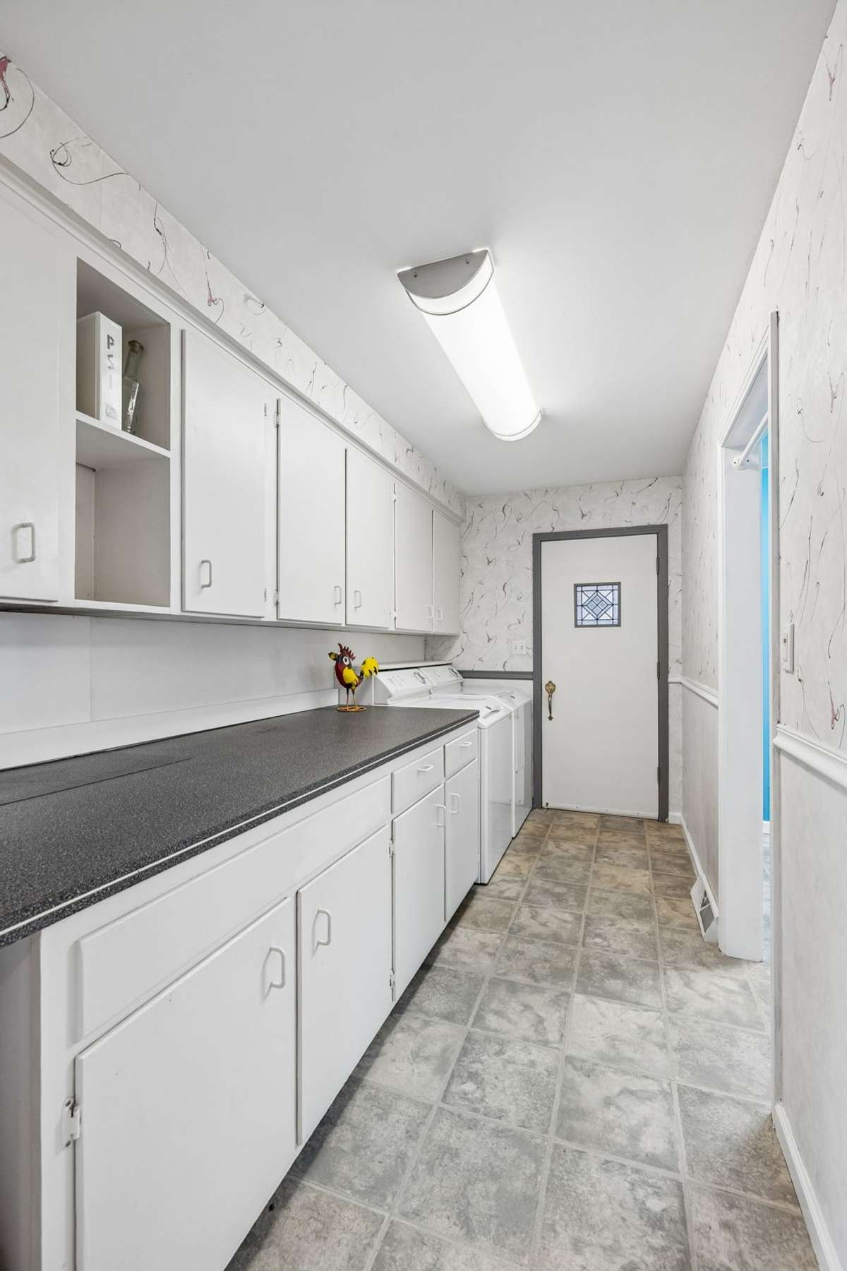 Large laundry room with cabinets and countertop