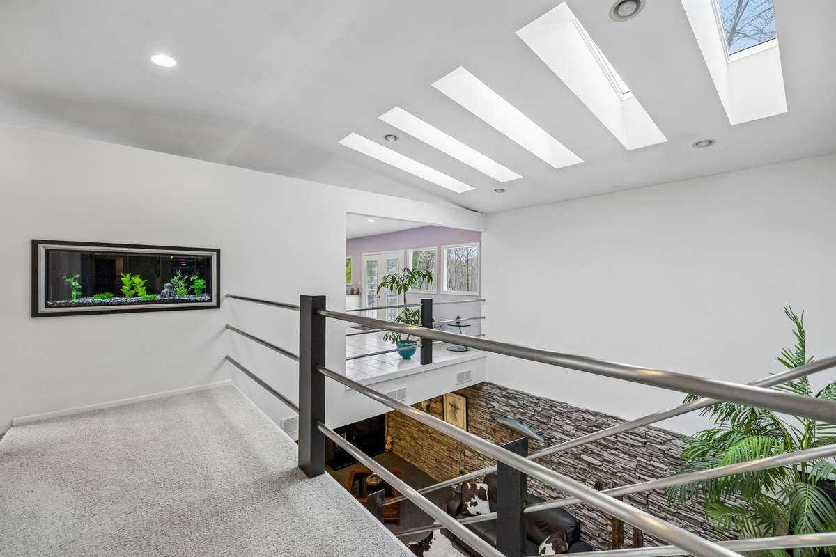 Walkway leading to master suite with built in aquarium