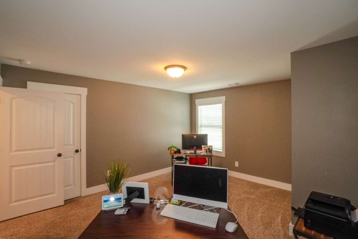 This is one of the 2 upstairs bedrooms seller is currently using as an office