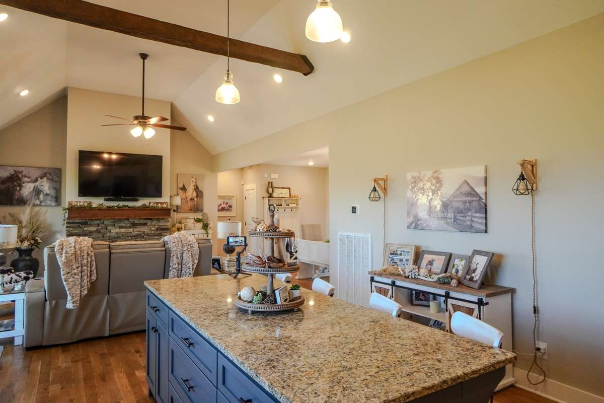 The kitchen  has a large island with enough seating for 4.