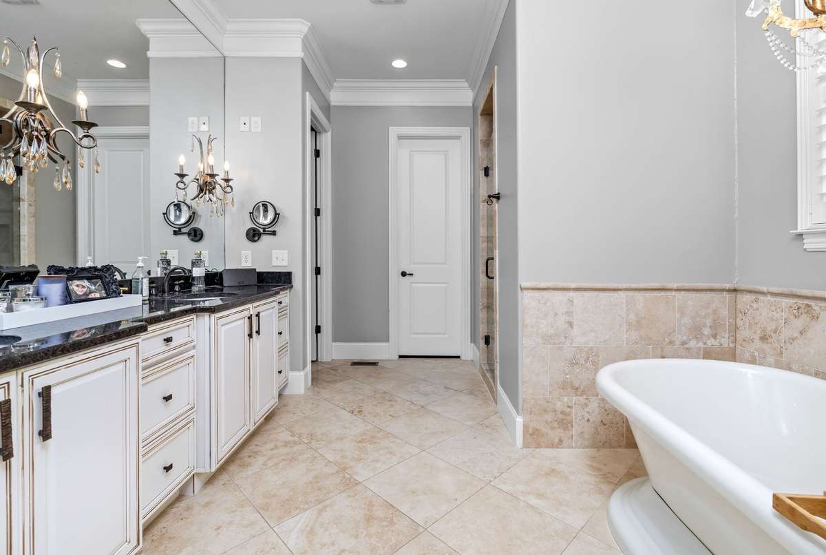 Primary bath with free standing tub and large walk in tiled shower