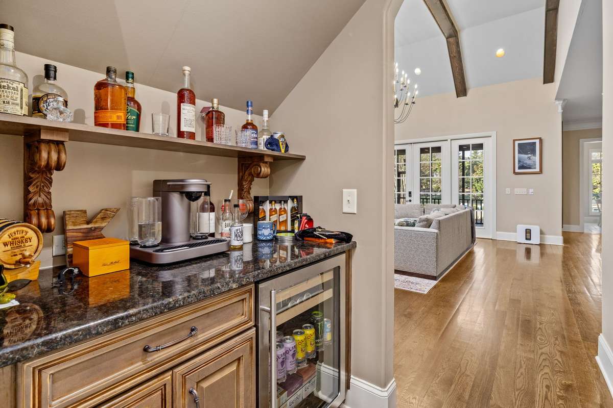 Wet bar and drinks fridge area between dining and kitchen