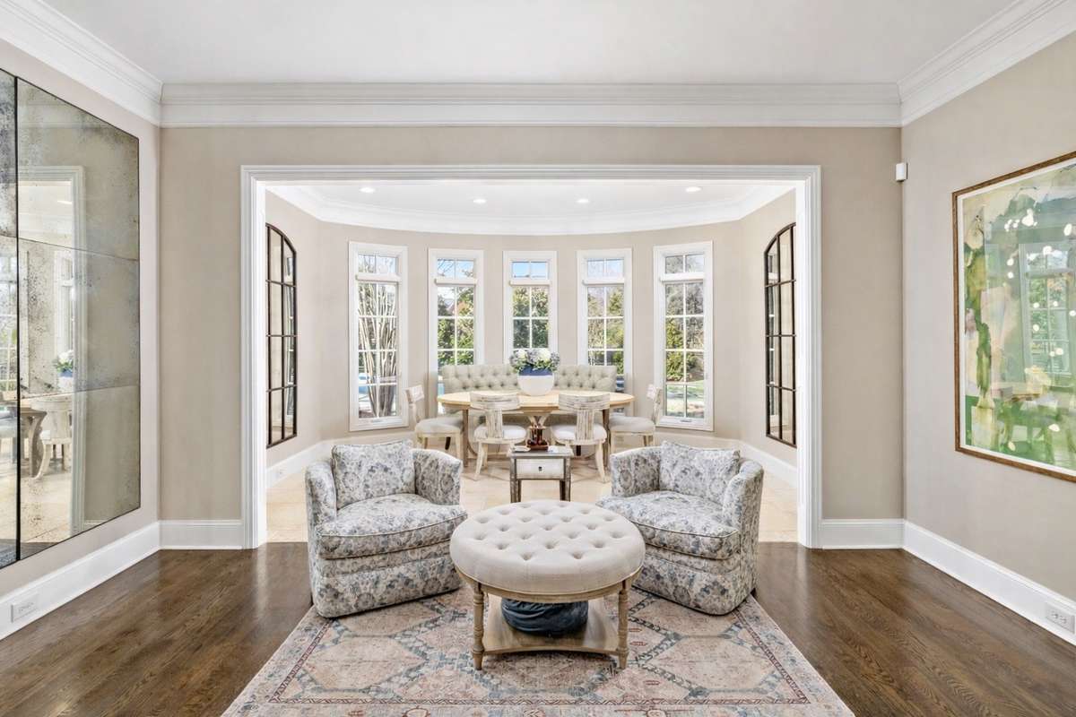 Scenic garden room off kitchen area drenched in natural light and views of the backyard oasis