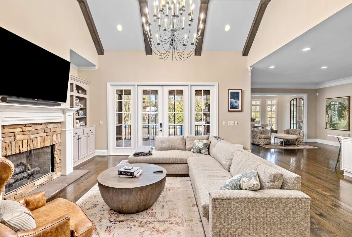 Beams add a flair with stone fireplace and built ins