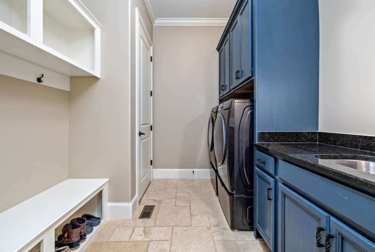 Laundry with sink, storage, cabinetry and mud room features