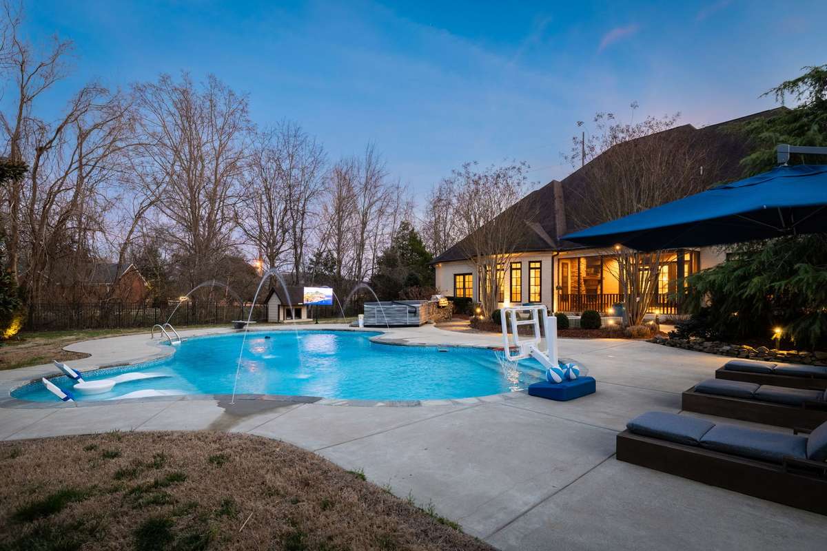 Beautiful pool with weatherproof outdoor tv, Sunbrella furnishings, and full backyard audio