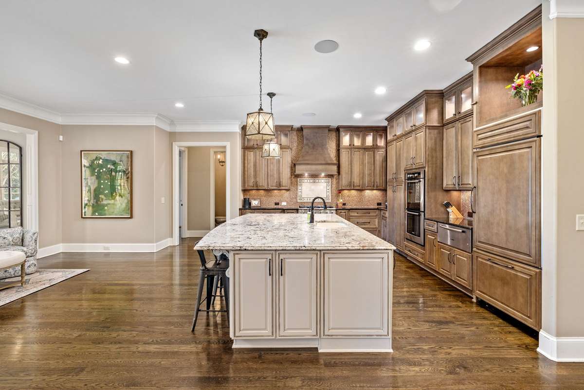Large oversized island, custom tile backsplash, beautiful built ins and Monogram / Bosch appliances