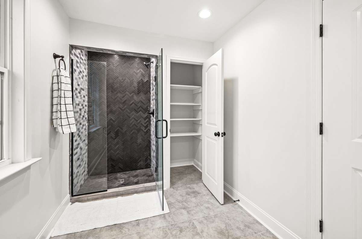 You will find a linen closet next to the shower.