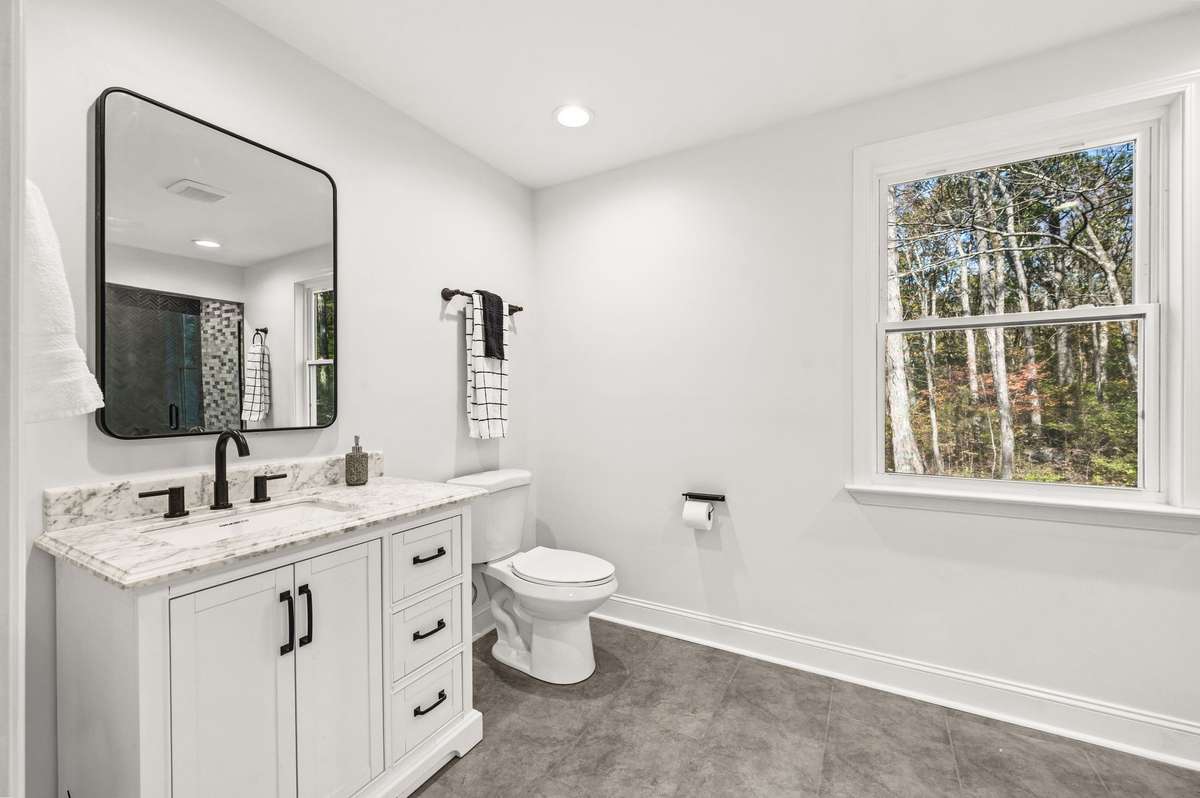 You will find a new vanity, new commode, new mirror and a gorgeous tiled shower in the primary bath.
