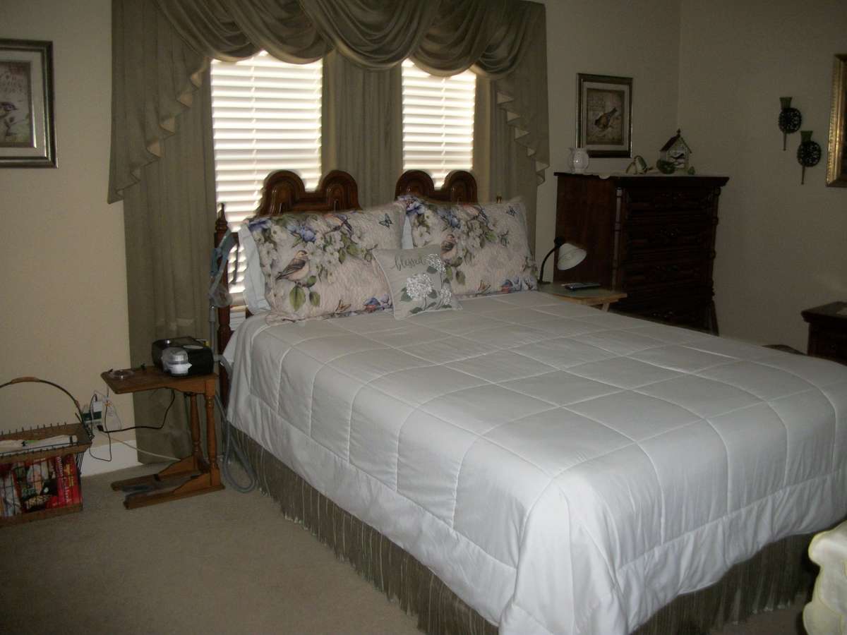 Primary Bedroom with wood floors under carpet