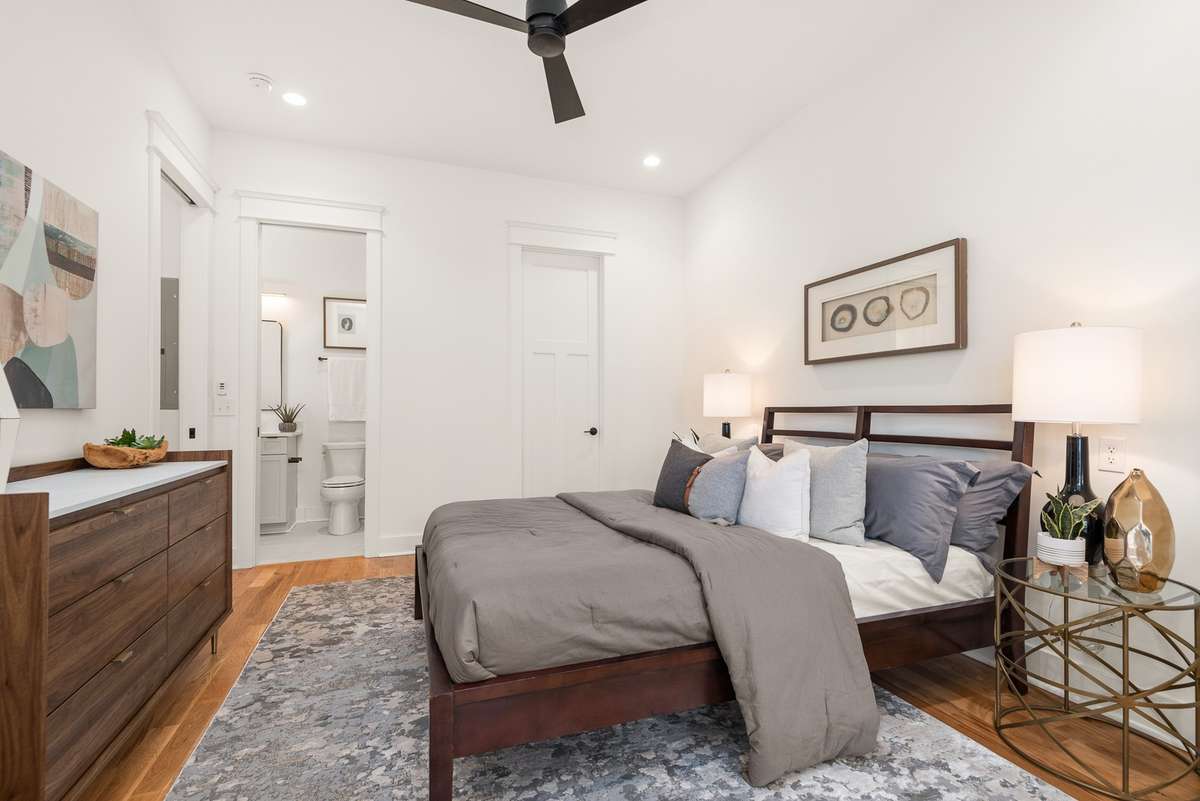 A main-level bedroom with a private en suite provides the option for comfortable one-floor living.