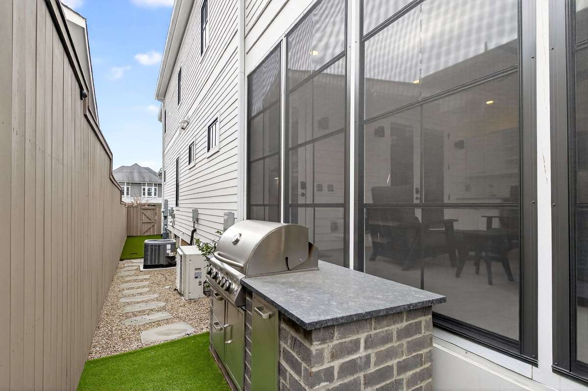 The sellers enhanced the outdoor space with pea gravel and stepping stones, forming an elevated dog run and walkway to the front of the home.