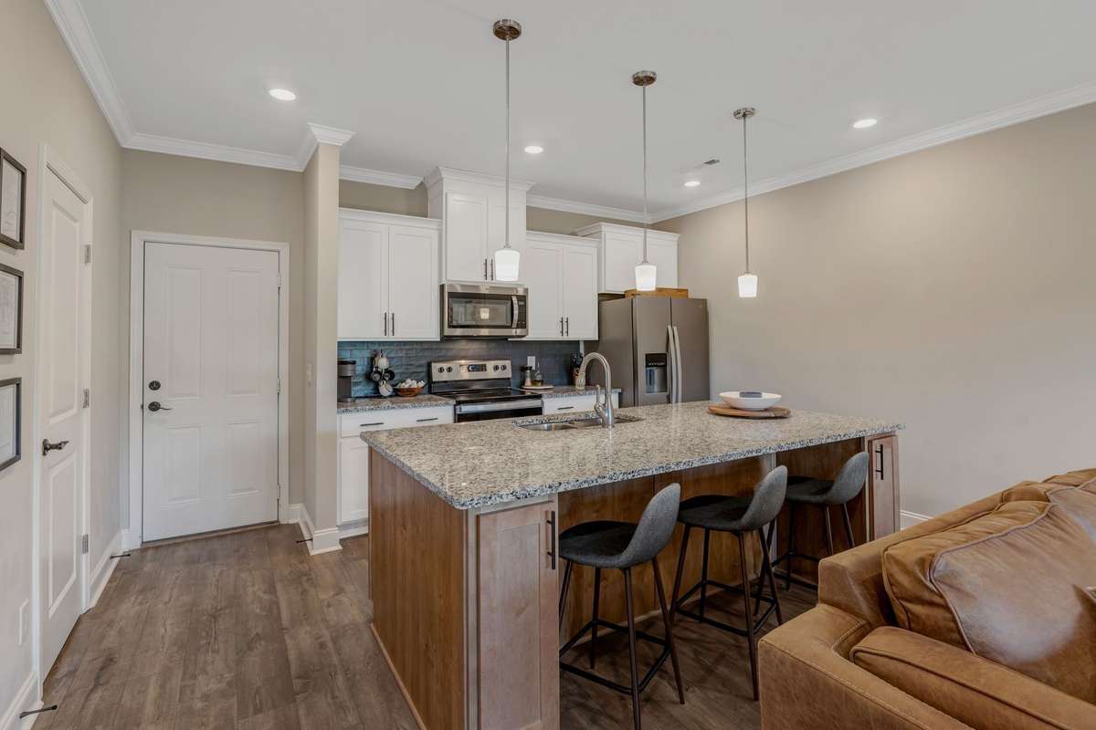 Beautiful kitchen with eat on island packed with storage