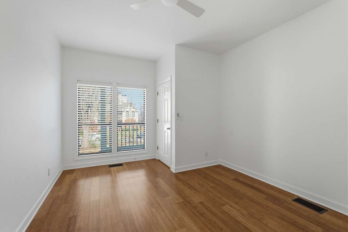 Bedroom on main level with ceiling fan