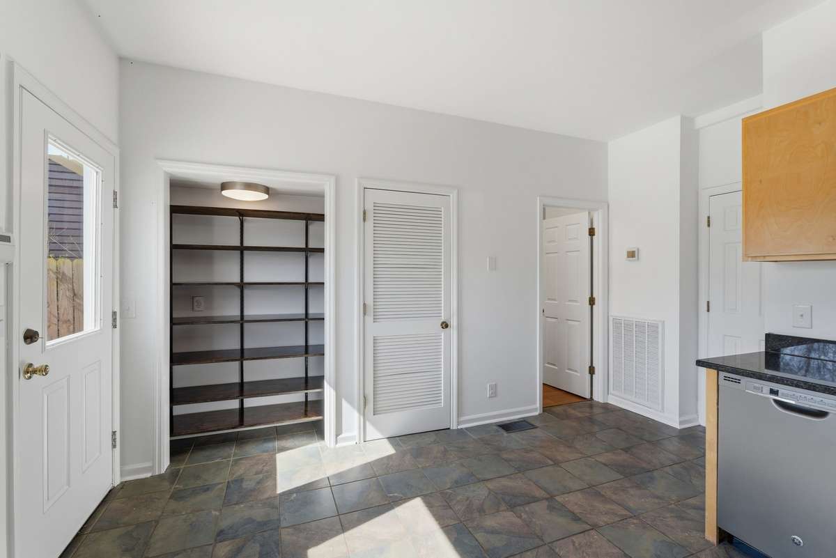 The kitchen has a pantry and ample cabinetry for plenty of storage