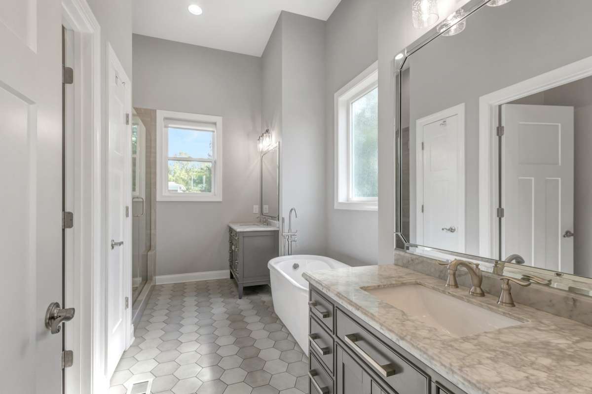 Double vanities, tub and 5 foot tile shower in primary bathroom.