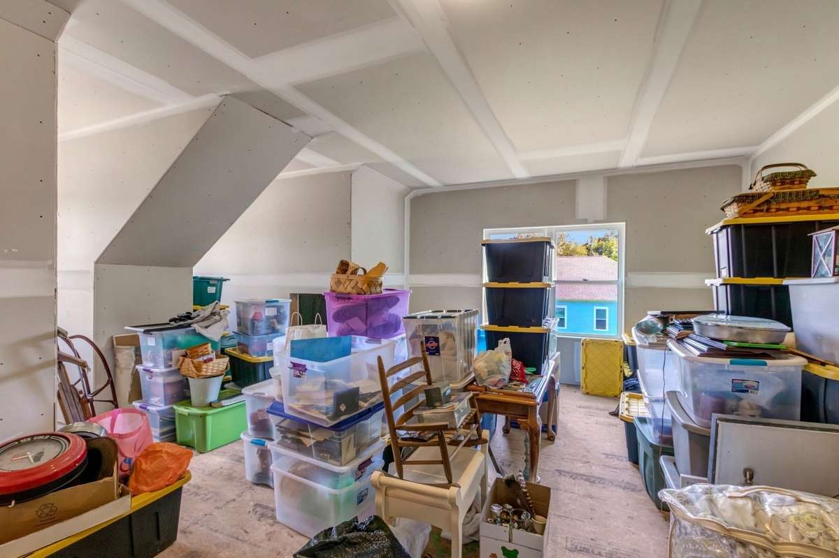 Partially finished bonus room with additional attic space for storage.