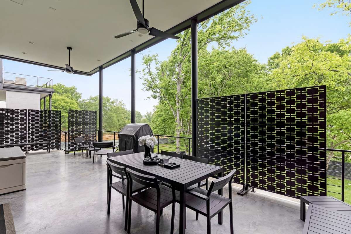 Relax and savor summer nights with a view of your private, tree-lined fenced backyard.
