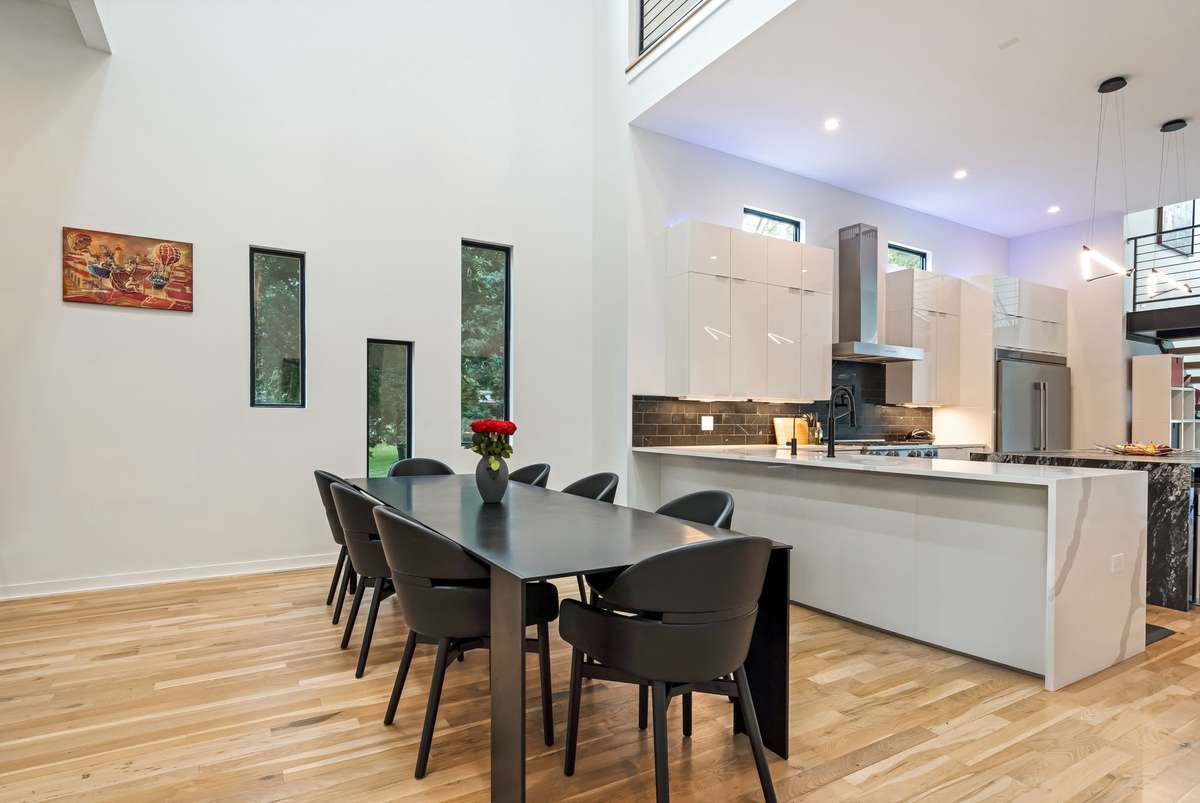 The dining room is highlighted by a dramatic 2-story ceiling, elevating the overall design and ambience.
