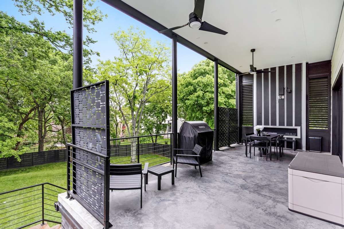 Full length covered porch features a built-in fireplace, two ceiling fans and is plumbed for gas grill