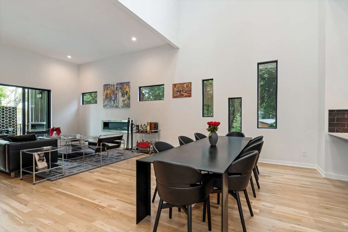 From the dining room, the space transitions into the expansive great room, perfect for both entertaining and everyday living