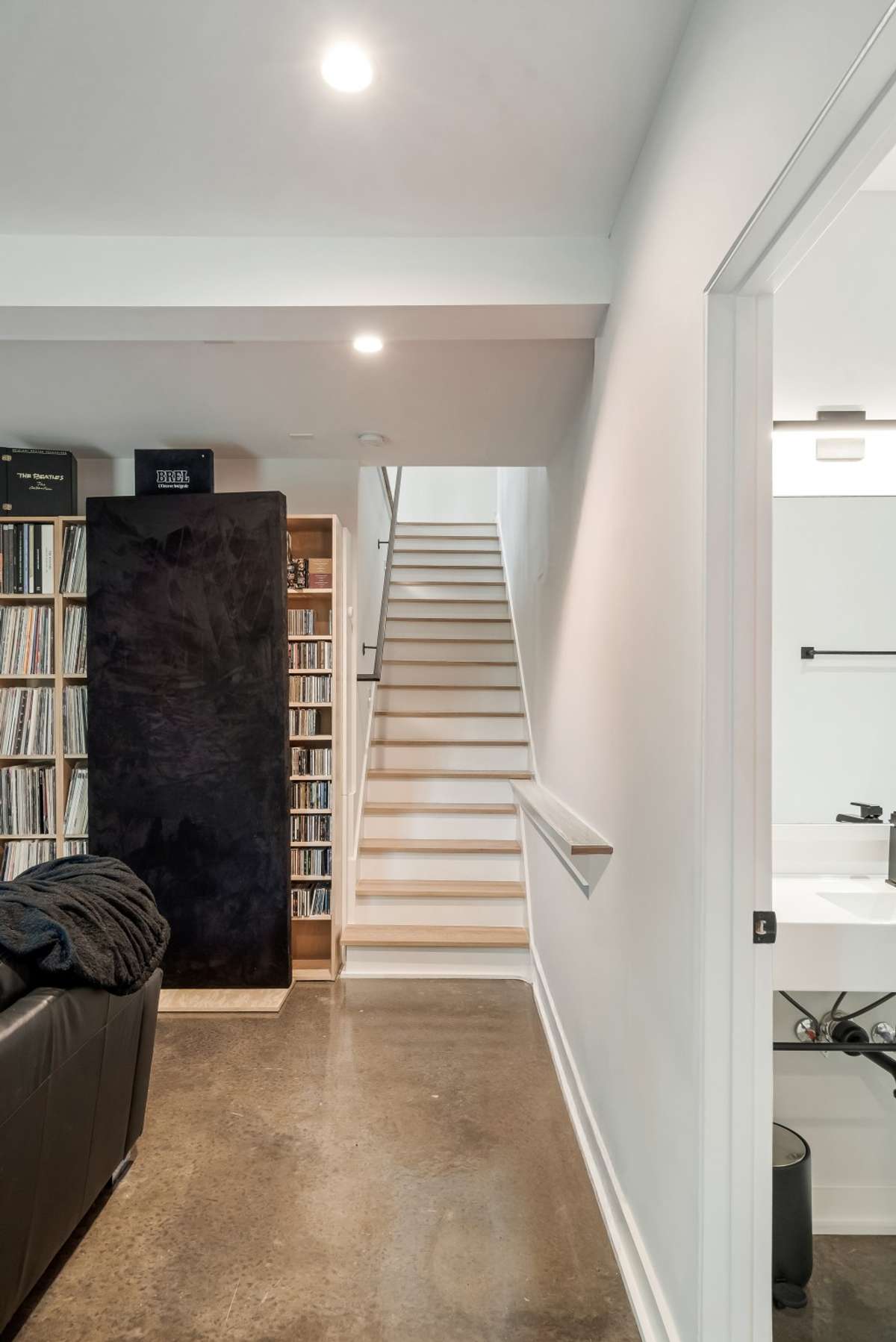 Open staircase leads to the versatile lower level
