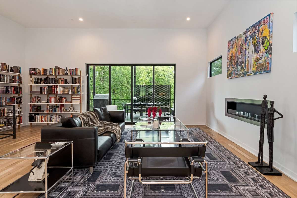 The multiple sliding patio doors open the entire great room to the large covered porch