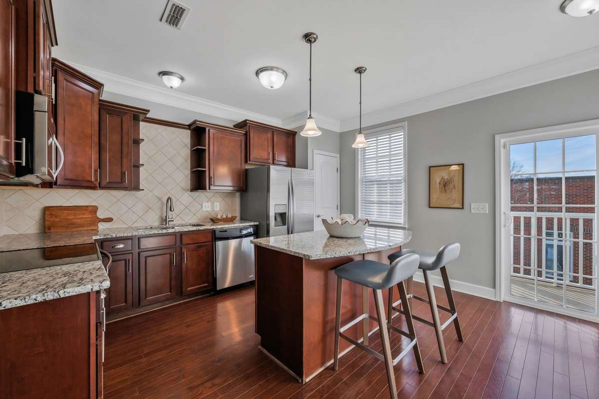 Great Kitchen! Granite counters, lots of cabinet storage, island for baking/bar, small balcony.