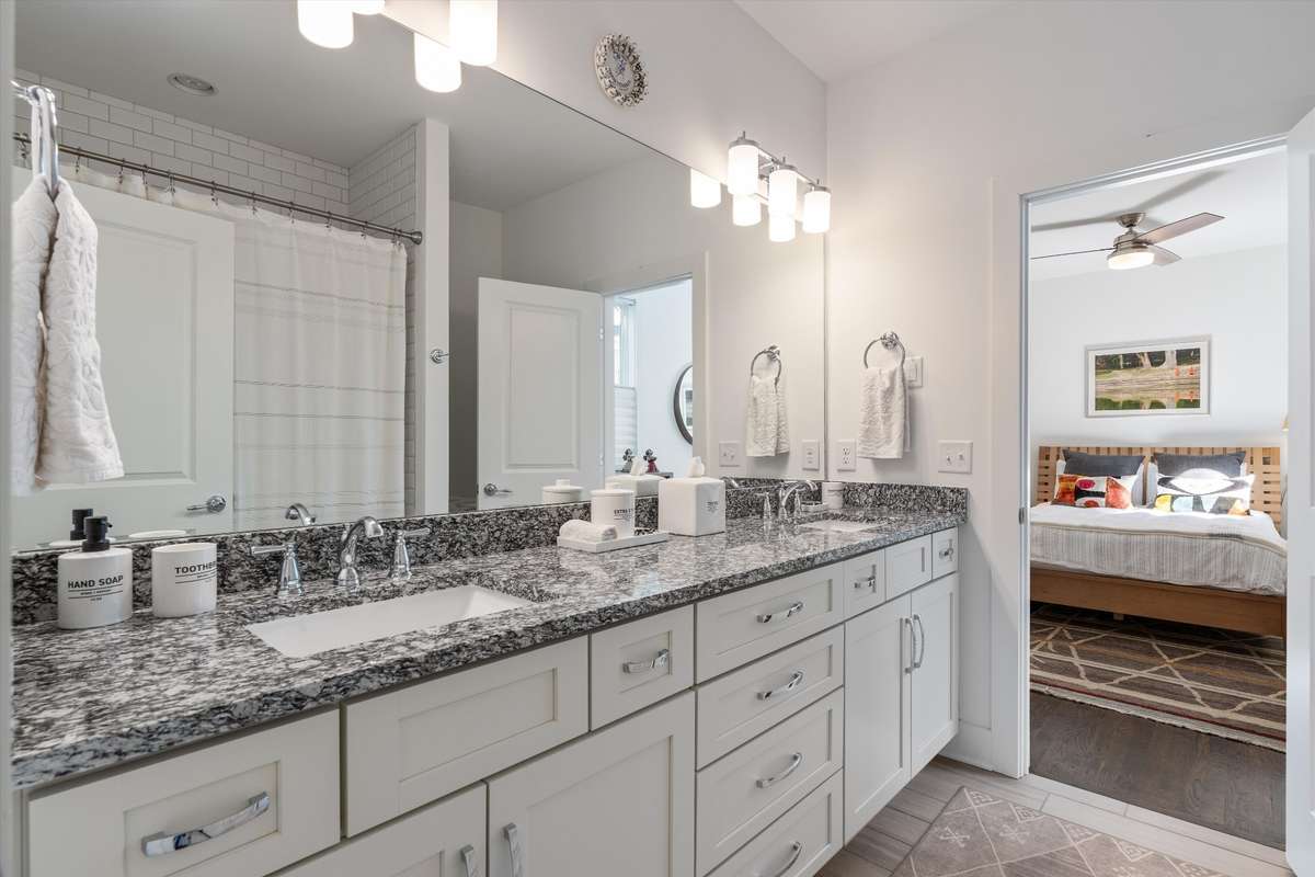 Guest bath with double vanities, loads of storage, and a bath/shower