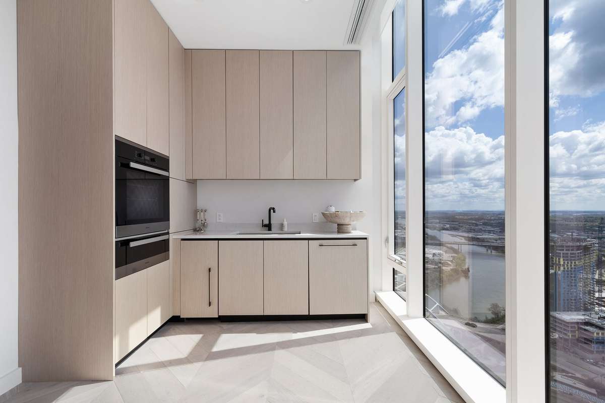 The catering kitchen features an oven, a warming drawer, an ice maker, sink, dishwasher, and a pantry.