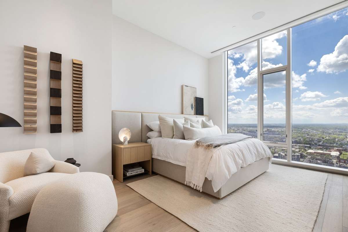 The guest bedroom features beautiful linens, furnishings, and sunrise views.