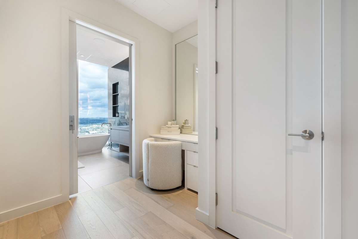 The primary bedroom features two separate bathrooms and closets.