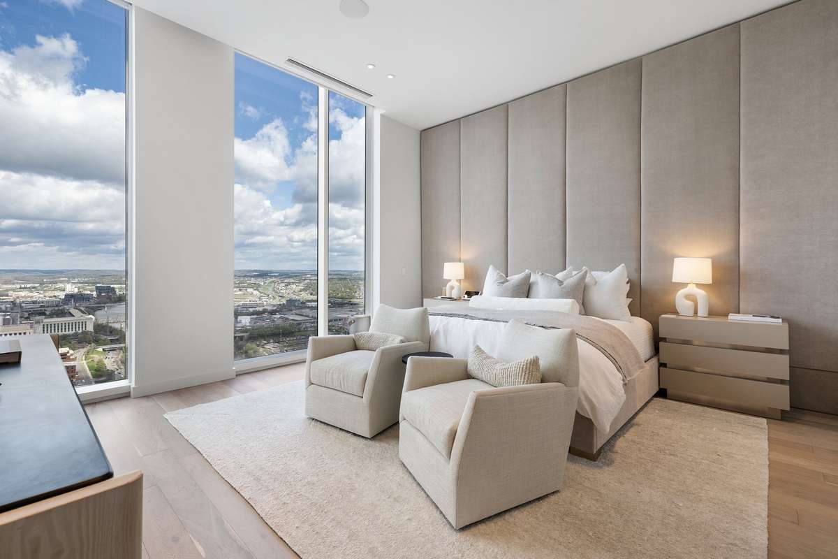 The primary bedroom is exquisitely furnished and has incredible views of the river and the lights of Broadway.