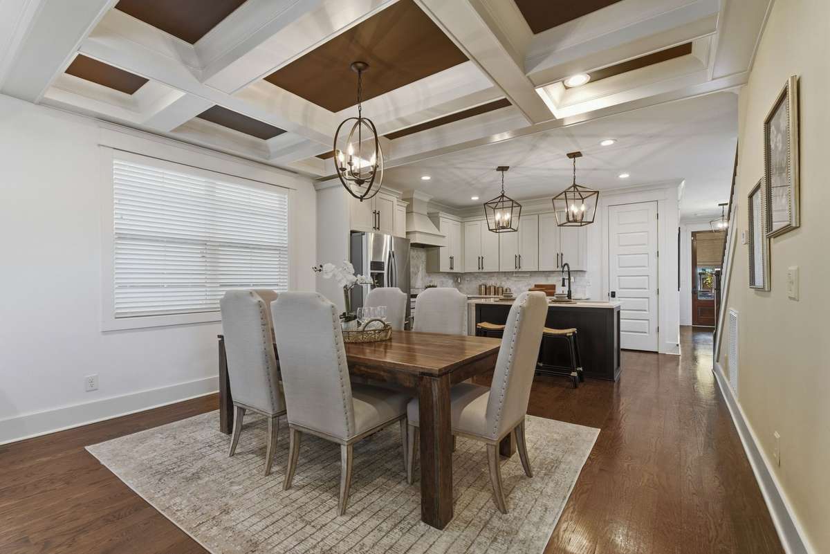 Formal dining room with decorative ceiling.