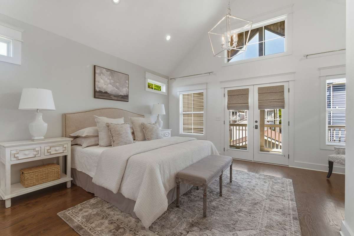 Primary suite with vaulted ceilings and a private balcony.