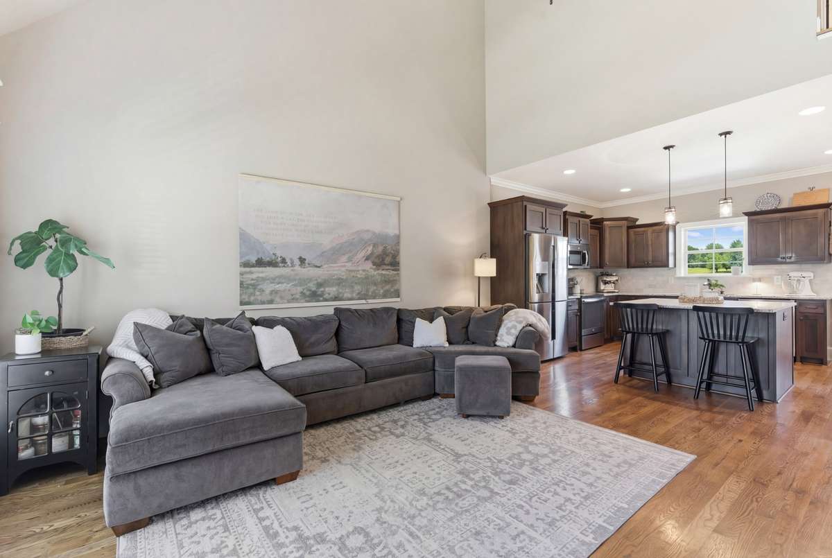 The sand and finish hardwood flooring is on all the main living area for great room, kitchen, and dining areas.